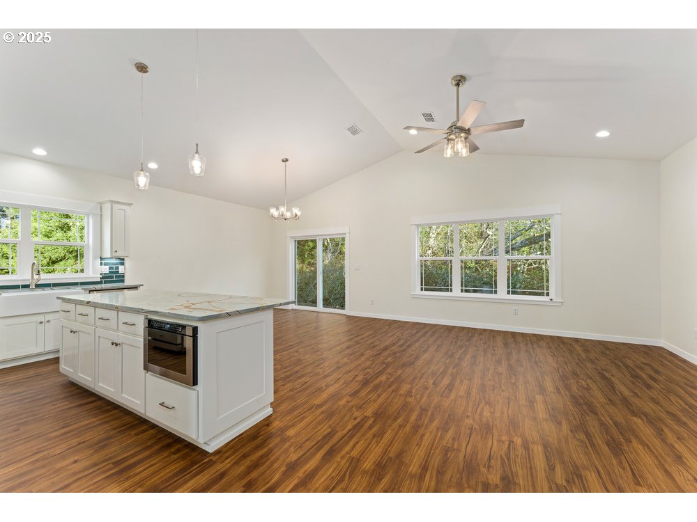 1241 Lighthouse Lane Brookings, OR 97415 - Photo 16 of 32 a kitchen with stainless steel appliances granite countertop a stove and a white cabinets
