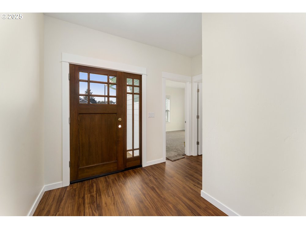 1241 Lighthouse Lane Brookings, OR 97415 - Photo 6 of 32 a view of an empty room with wooden floor and closet