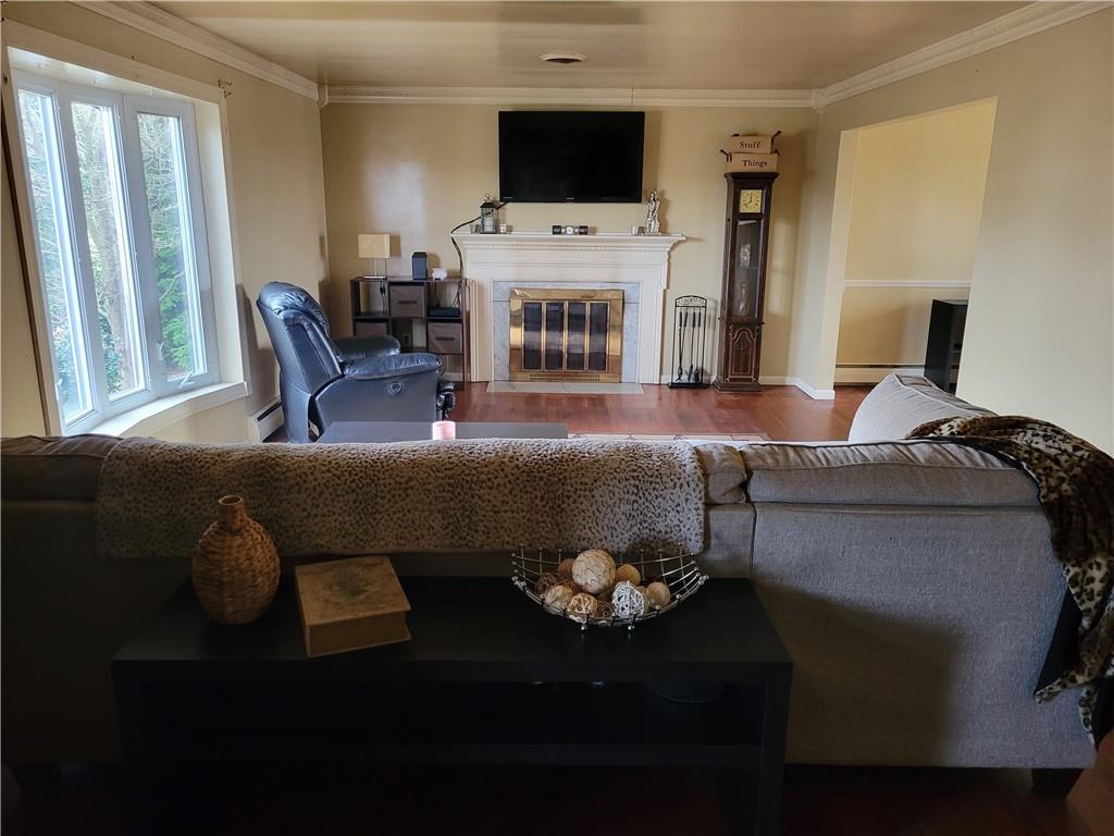 676 Davidson Drive Rochester, PA 15074 - Photo 5 of 24 a living room with furniture a fireplace and a flat screen tv