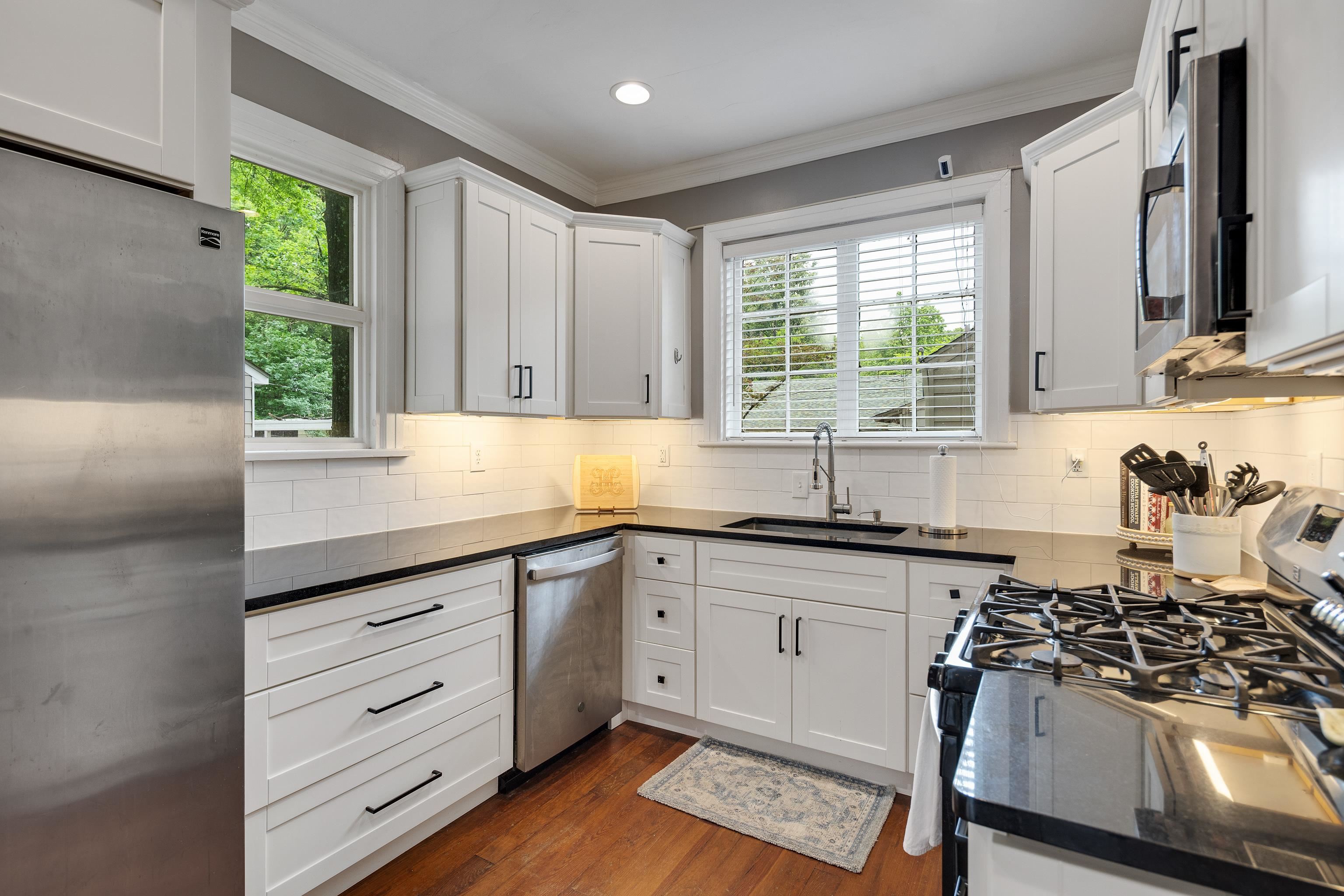 555 South Holmes Street Memphis, TN 38111 - Photo 10 of 40 a kitchen with granite countertop a sink stainless steel appliances and cabinets