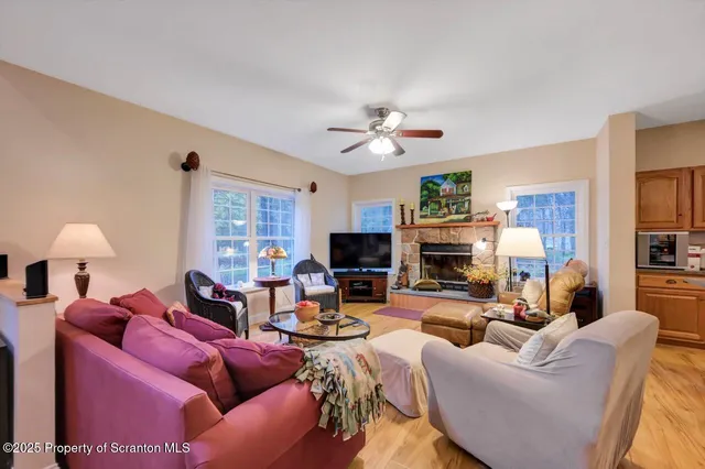 a living room with a couch a flat screen tv and a fireplace