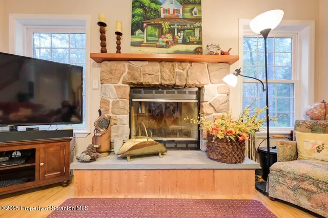 a kitchen with stainless steel appliances kitchen island granite countertop a dining table chairs and a refrigerator