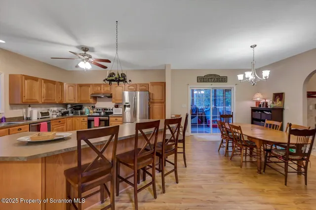 a view of a dining room with furniture and chandelier