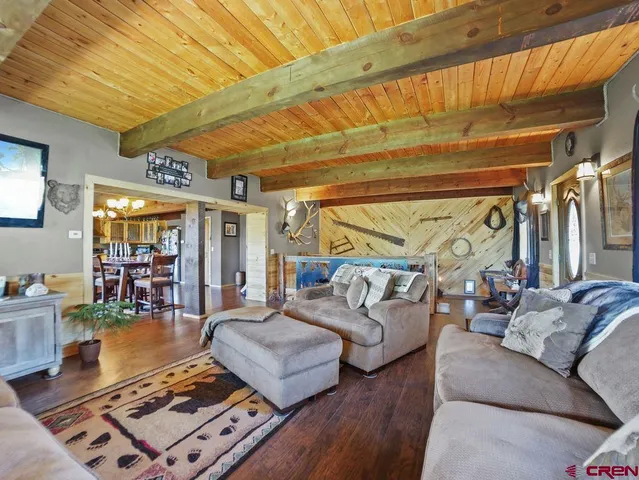 a dining room with wooden floor and large glass windows