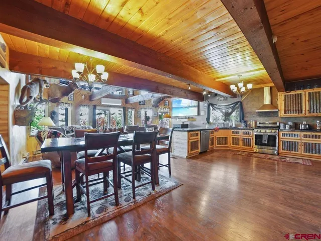a living room with fireplace furniture and a large window