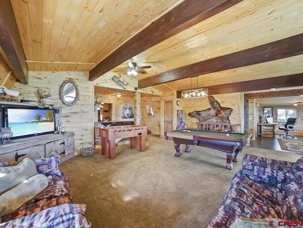 a reading room with furniture and a rug