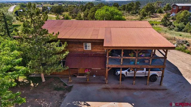 an aerial view of a house with garden space and sitting area