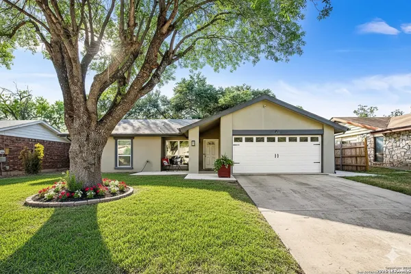 a large house with a large tree in front of it