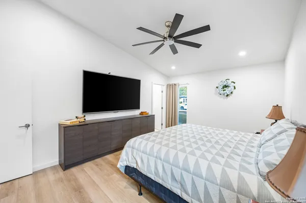 a bedroom with a bed and a flat screen tv