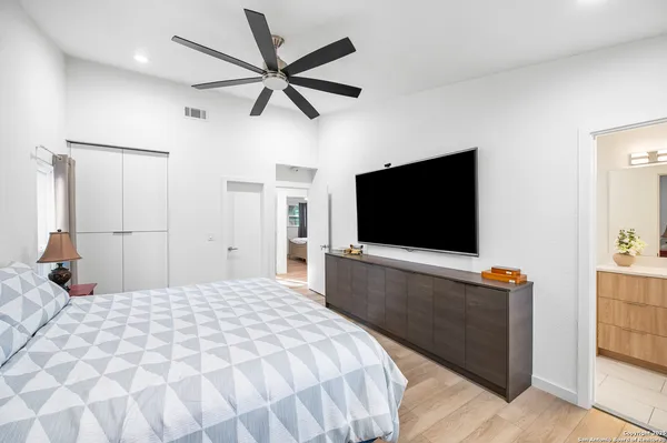 a bedroom with a bed and a flat screen tv