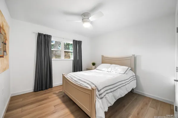 a bed sitting in a bedroom next to a window