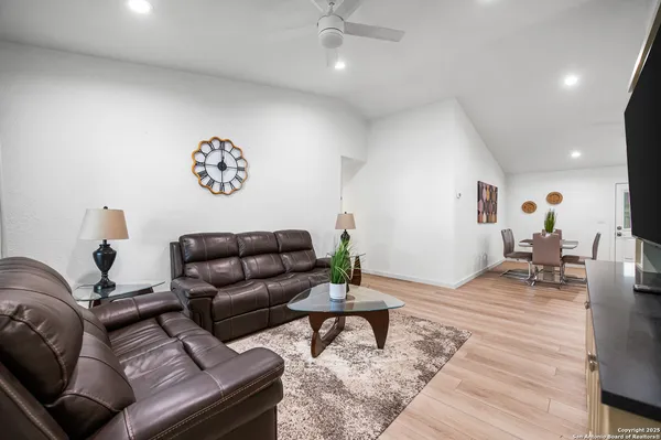 a living room with furniture and a wooden floor