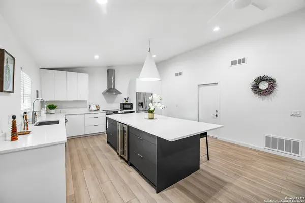 a kitchen with a sink microwave and cabinets