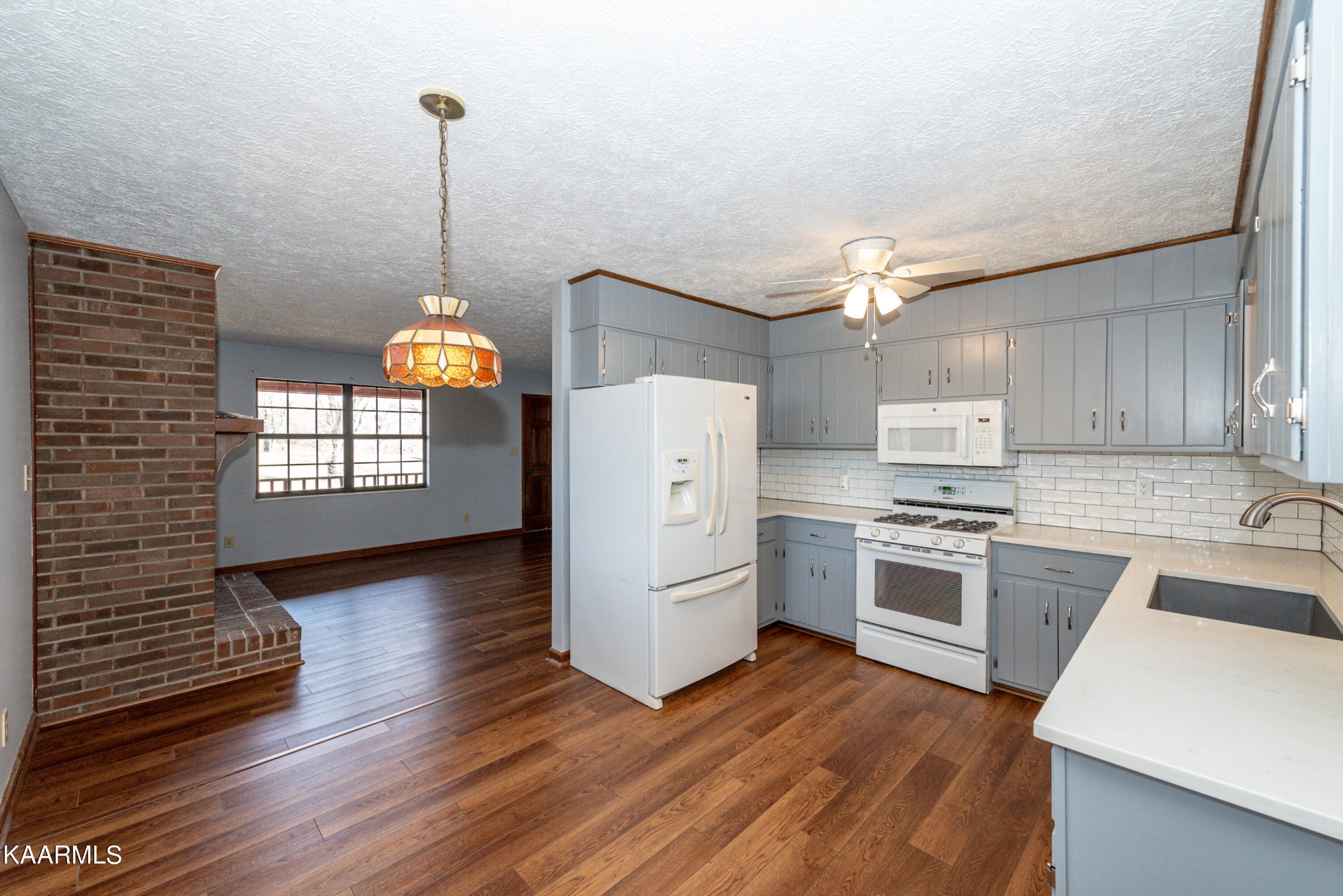 913 Mt Lebanon Road Maryville, TN 37804 - Photo 13 of 33 a kitchen with a refrigerator a stove top oven and a wooden floor
