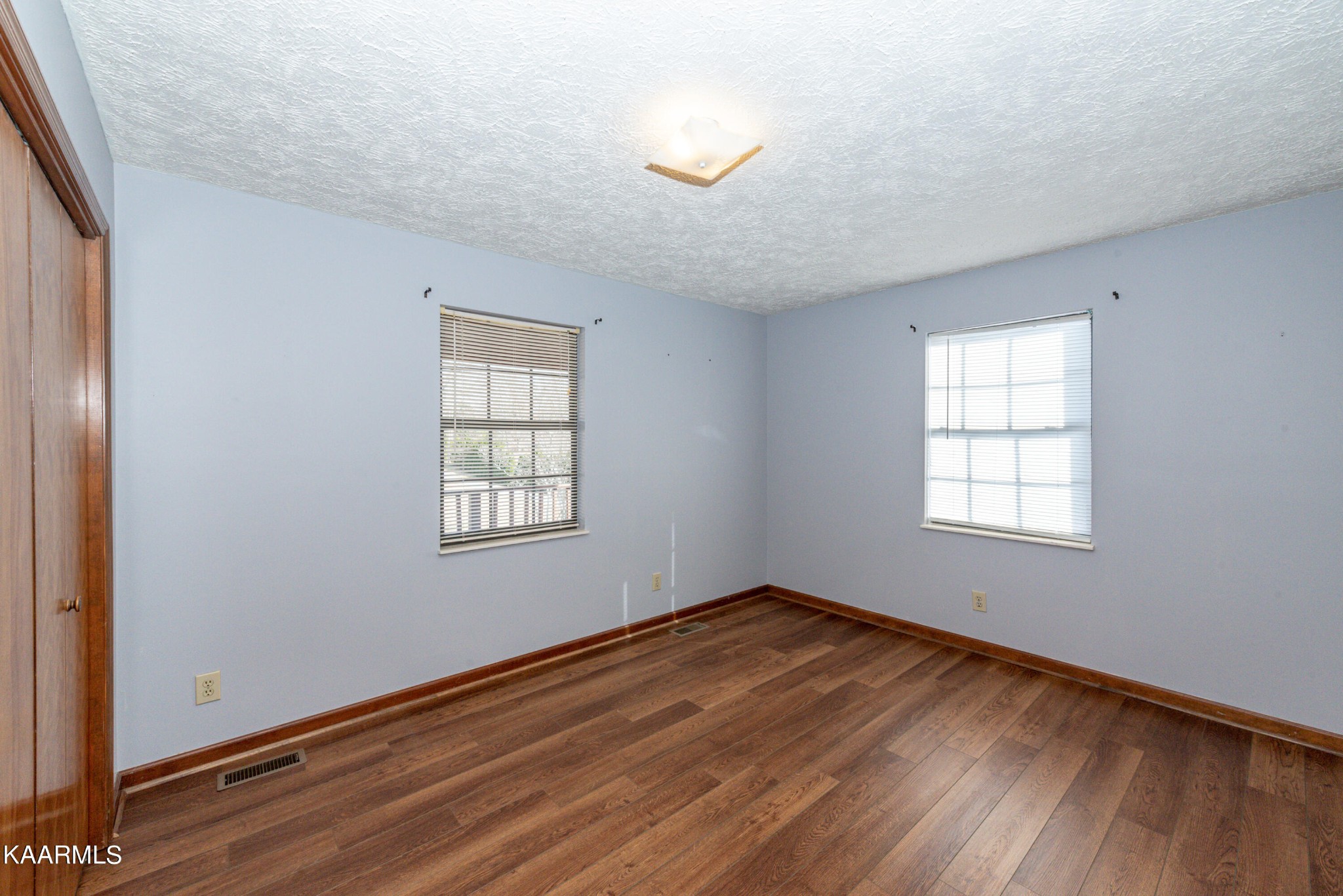 913 Mt Lebanon Road Maryville, TN 37804 - Photo 17 of 33 a view of an empty room with wooden floor and a window