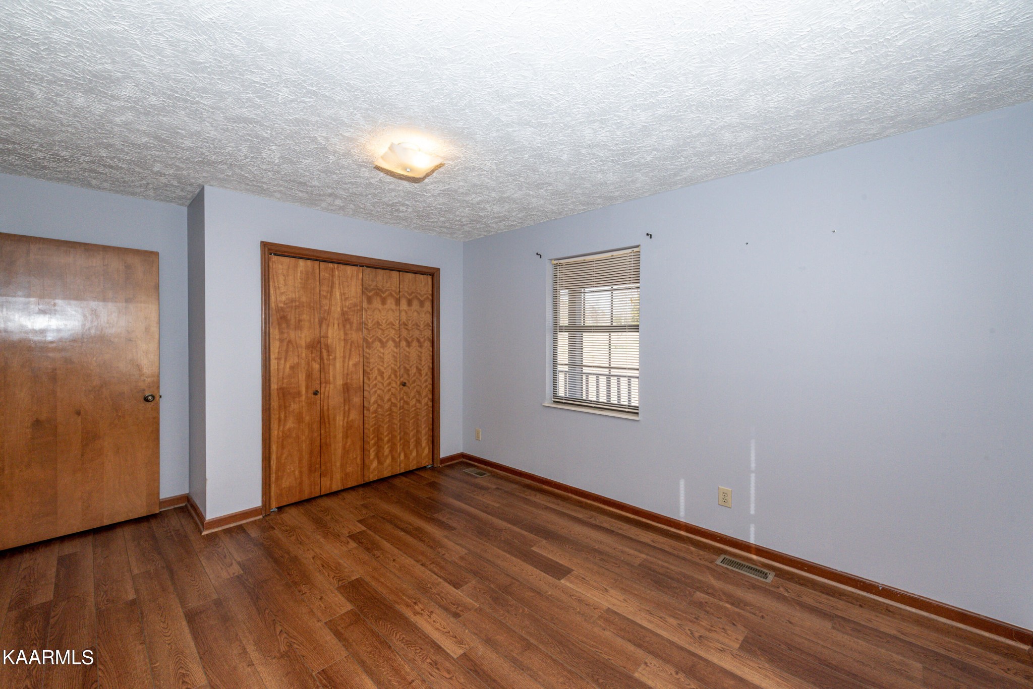 913 Mt Lebanon Road Maryville, TN 37804 - Photo 18 of 33 an empty room with wooden floor and windows
