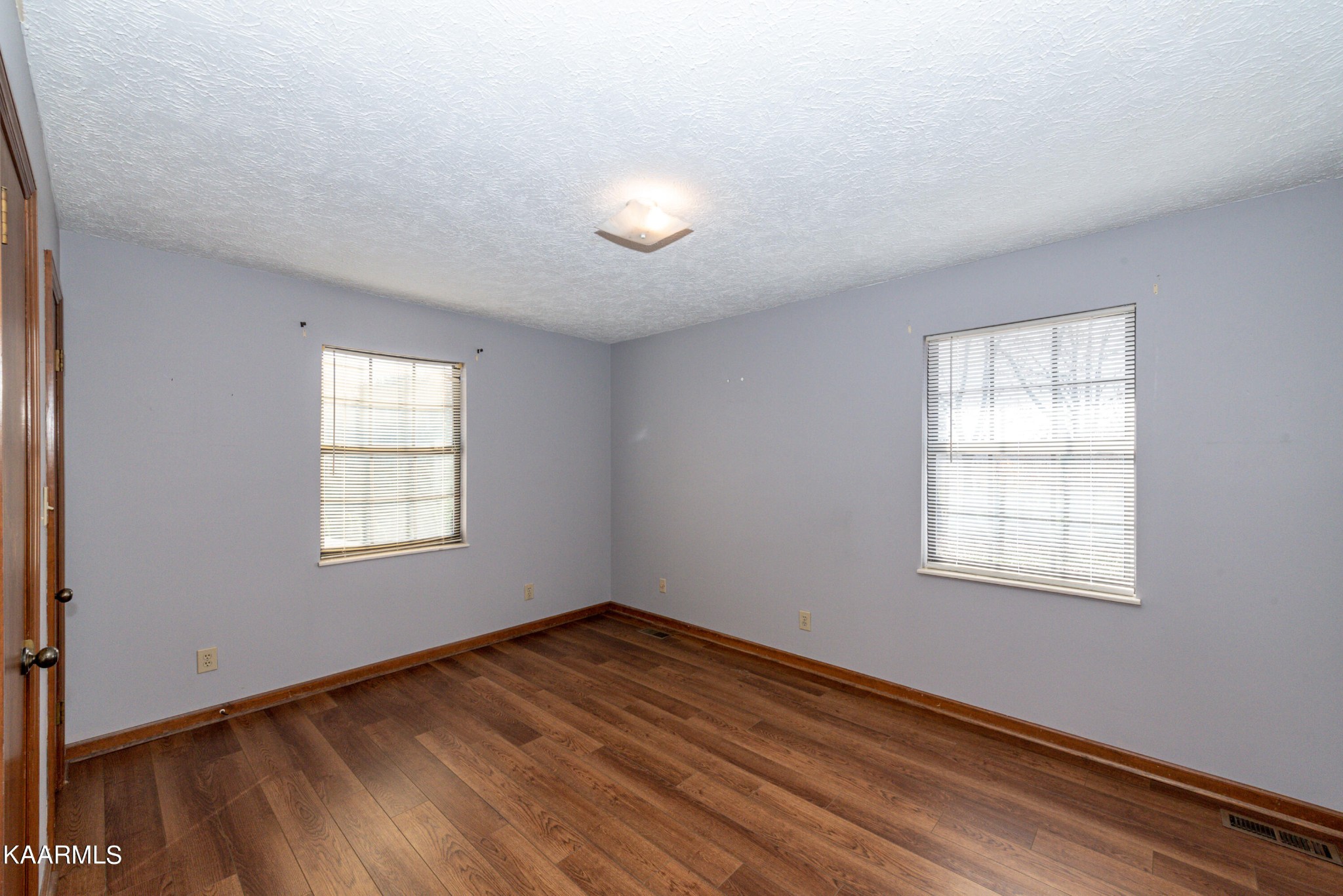 913 Mt Lebanon Road Maryville, TN 37804 - Photo 19 of 33 an empty room with wooden floor and windows
