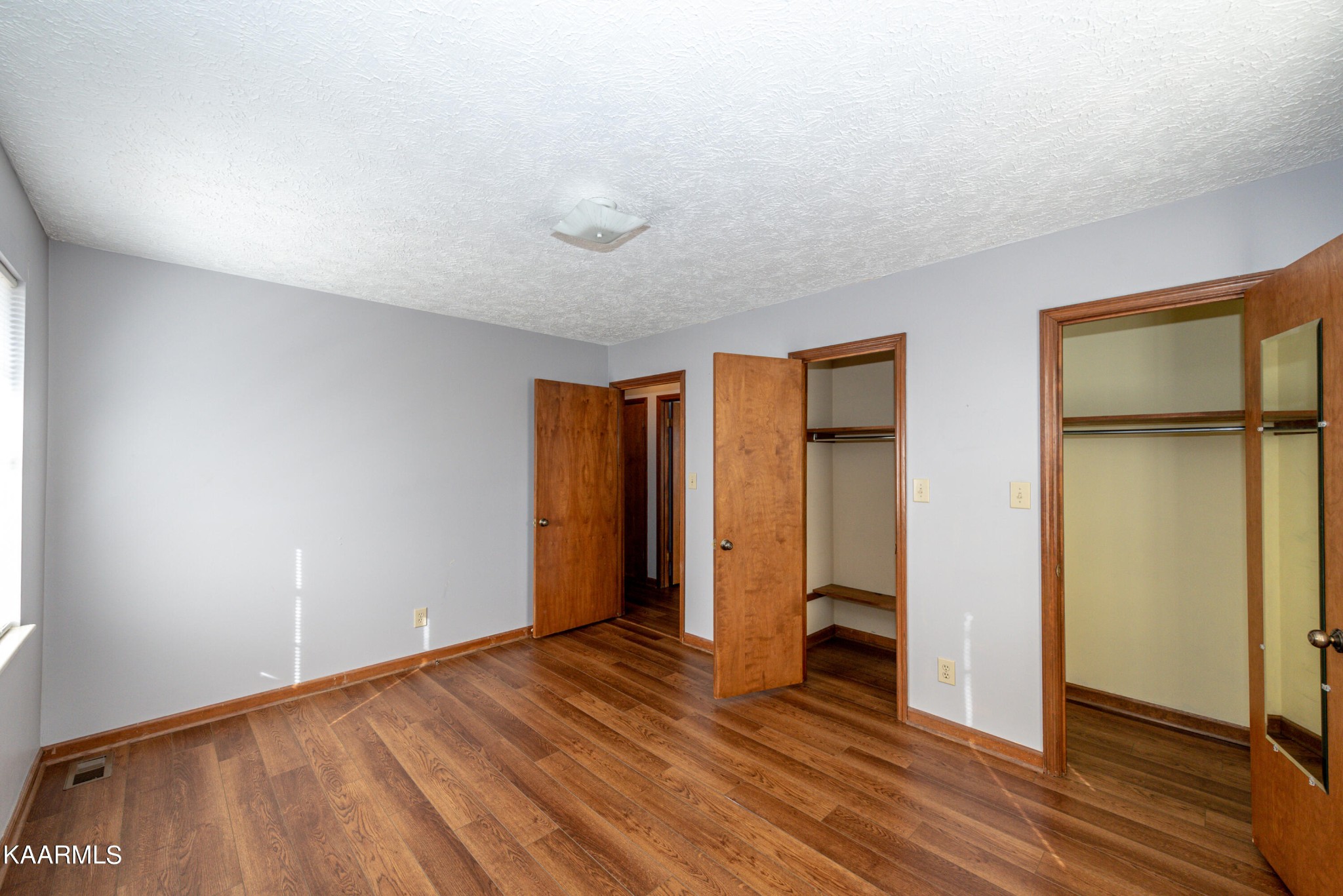 913 Mt Lebanon Road Maryville, TN 37804 - Photo 21 of 33 a view of an empty room with wooden floor and a window