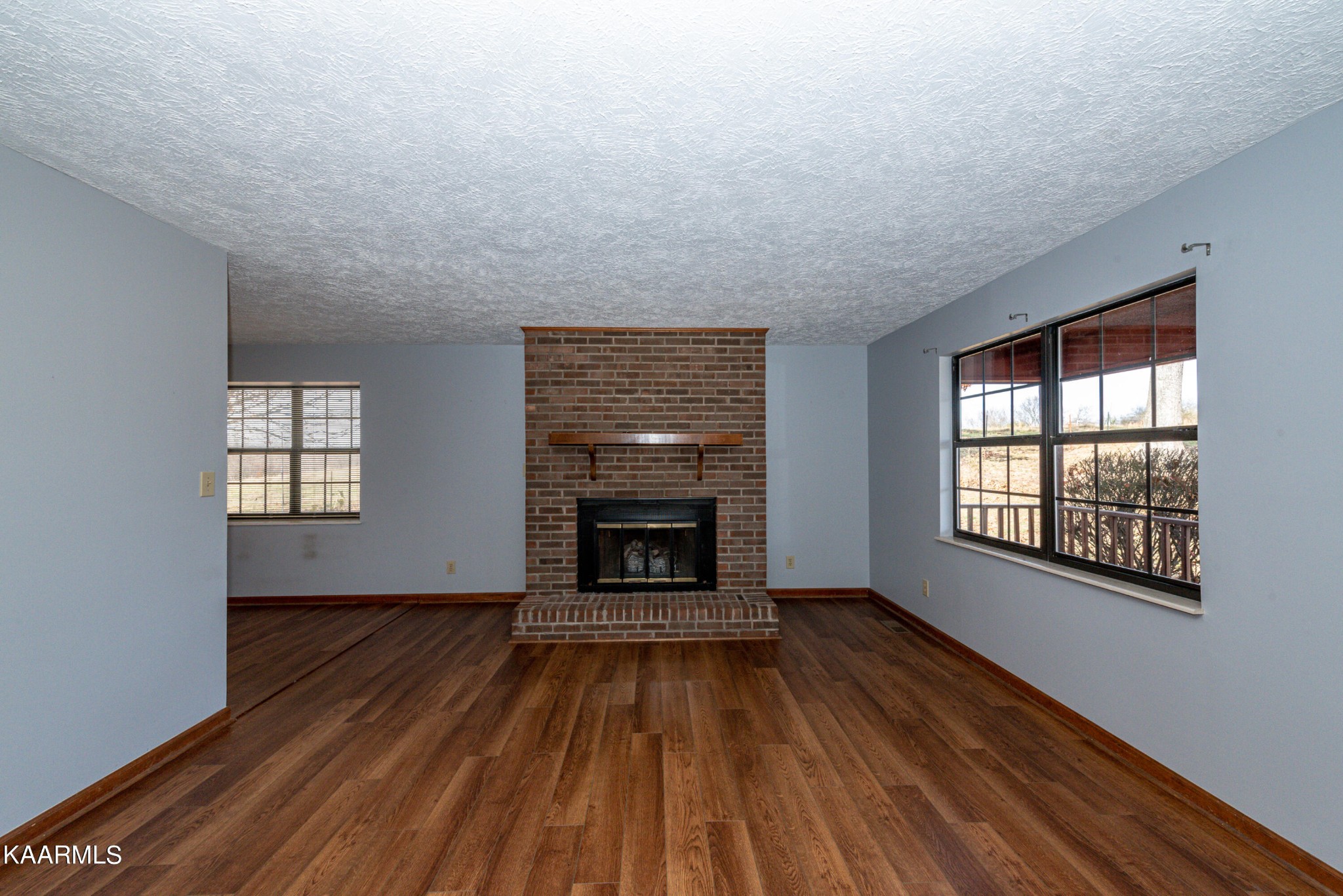 913 Mt Lebanon Road Maryville, TN 37804 - Photo 8 of 33 a view of an empty room with wooden floor fireplace and a window