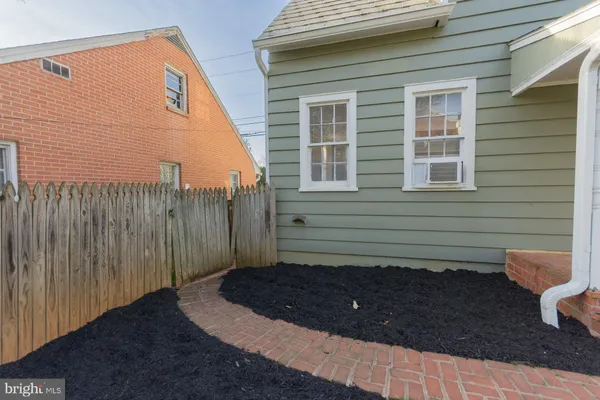 a view of a house with a big yard and large trees