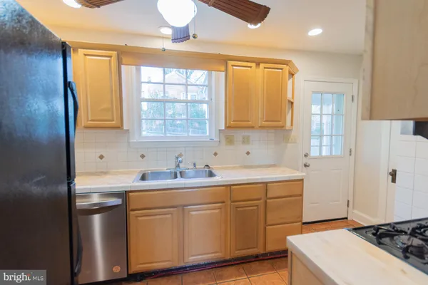 a white toilet sitting next to a bathroom sink