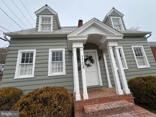 a front view of a house with a garden and plants