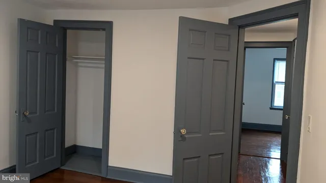 a view of hallway with wooden floor