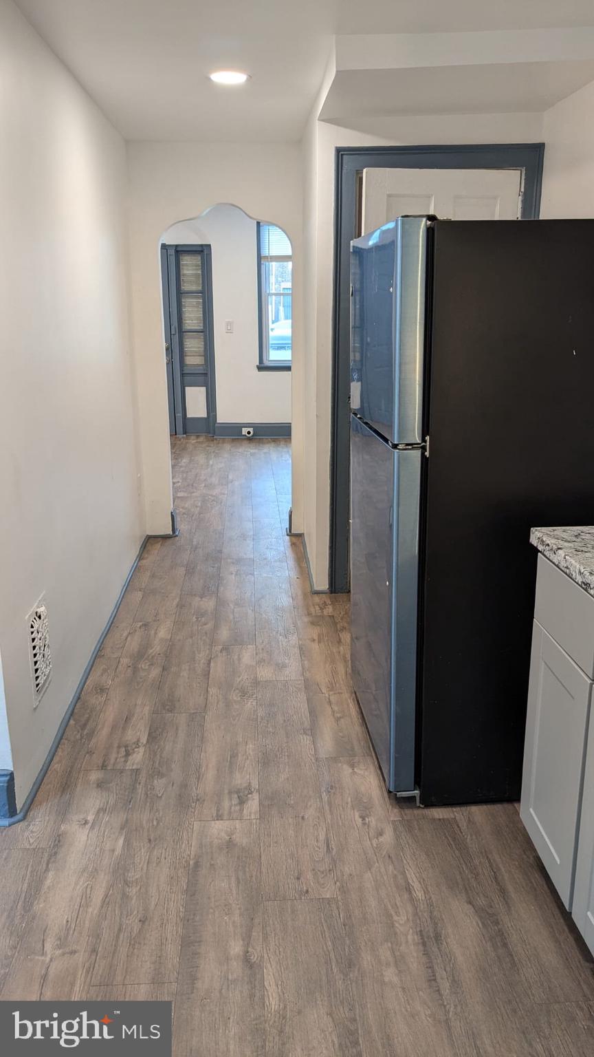 2909 Yorkship Road Camden, NJ 08104 - Photo 16 of 24 a view of a refrigerator in kitchen and an empty room with windows
