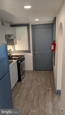 a view of a kitchen with refrigerator and stove