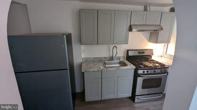 a kitchen with a stove and a refrigerator