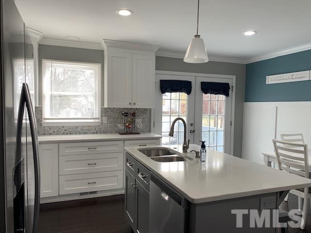 4208 Traders Dock Court Raleigh, NC 27616 - Photo 2 of 9 a kitchen with granite countertop a sink and white cabinets