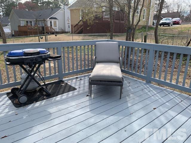 4208 Traders Dock Court Raleigh, NC 27616 - Photo 7 of 9 a view of a balcony with chairs and wooden floor