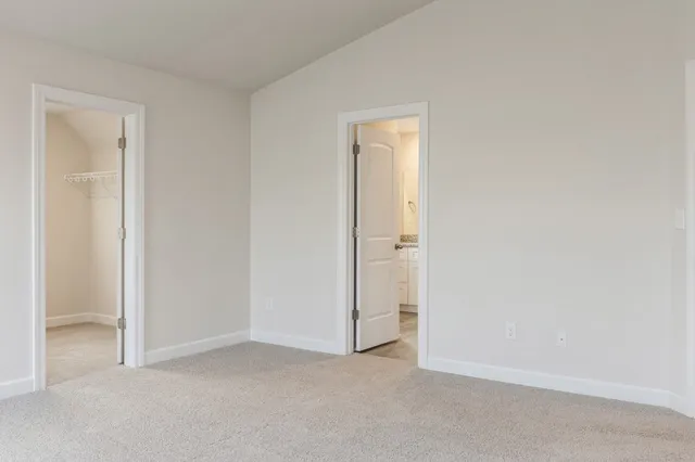 a view of an empty room and closet area