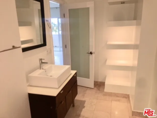 a bathroom with a sink a vanity and a mirror