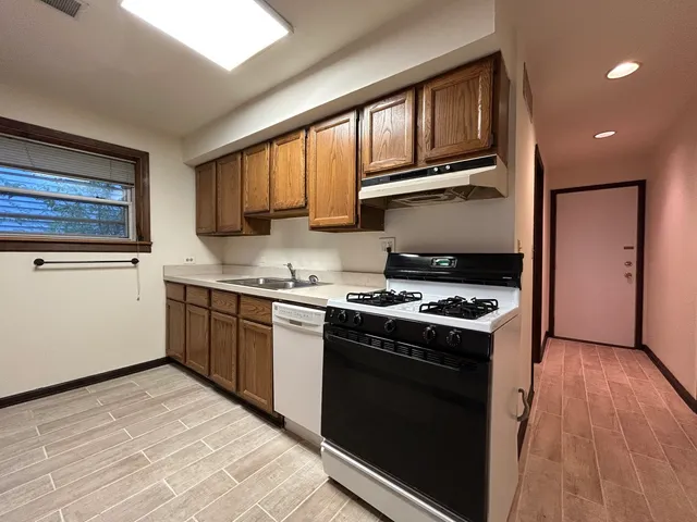 a kitchen with stainless steel appliances granite countertop a stove a sink dishwasher and a refrigerator