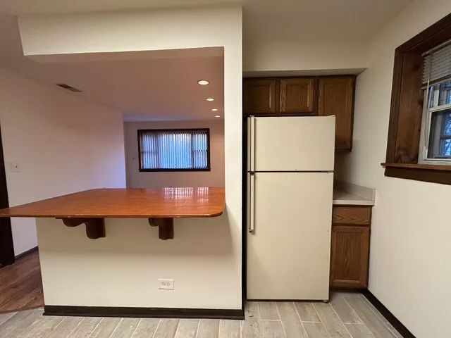 a view of a refrigerator in a kitchen