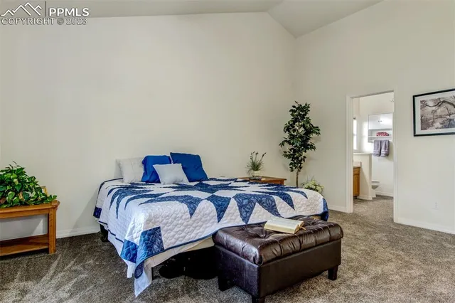 a bedroom with a bed and a potted plant
