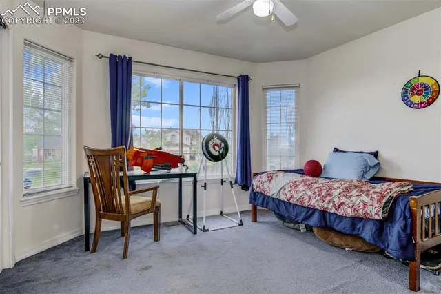 a bedroom with bed and a window