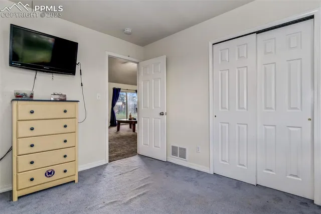 a view of room with cabinet flat screen tv and windows