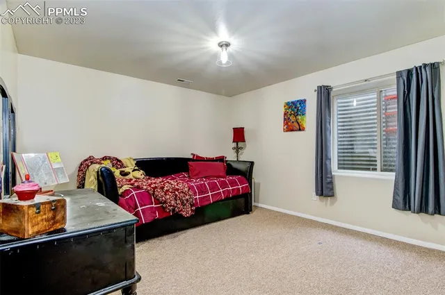 a bedroom with a bed and window