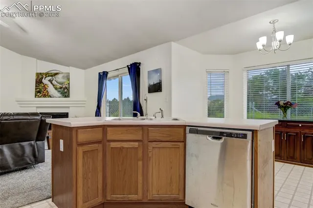 a view of cabinets a sink and a window in a room