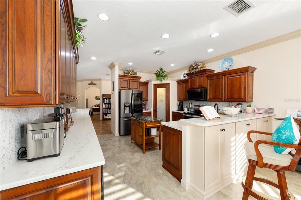 15694 Southwest 16th Avenue Road Ocala, FL 34473 - Photo 13 of 42 a view of a kitchen with kitchen island and stainless steel appliances