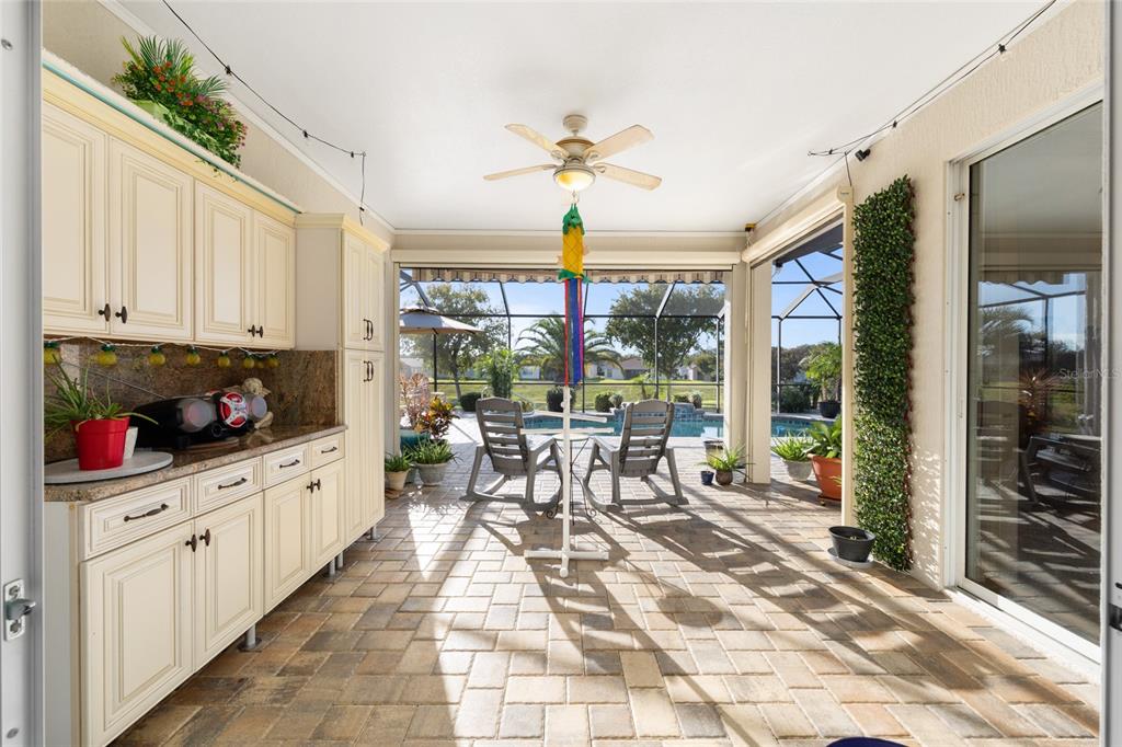 15694 Southwest 16th Avenue Road Ocala, FL 34473 - Photo 32 of 42 a open kitchen with granite countertop a stove a sink and a refrigerator
