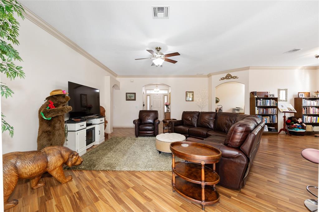 15694 Southwest 16th Avenue Road Ocala, FL 34473 - Photo 8 of 42 a living room with furniture gym equipment and a flat screen tv