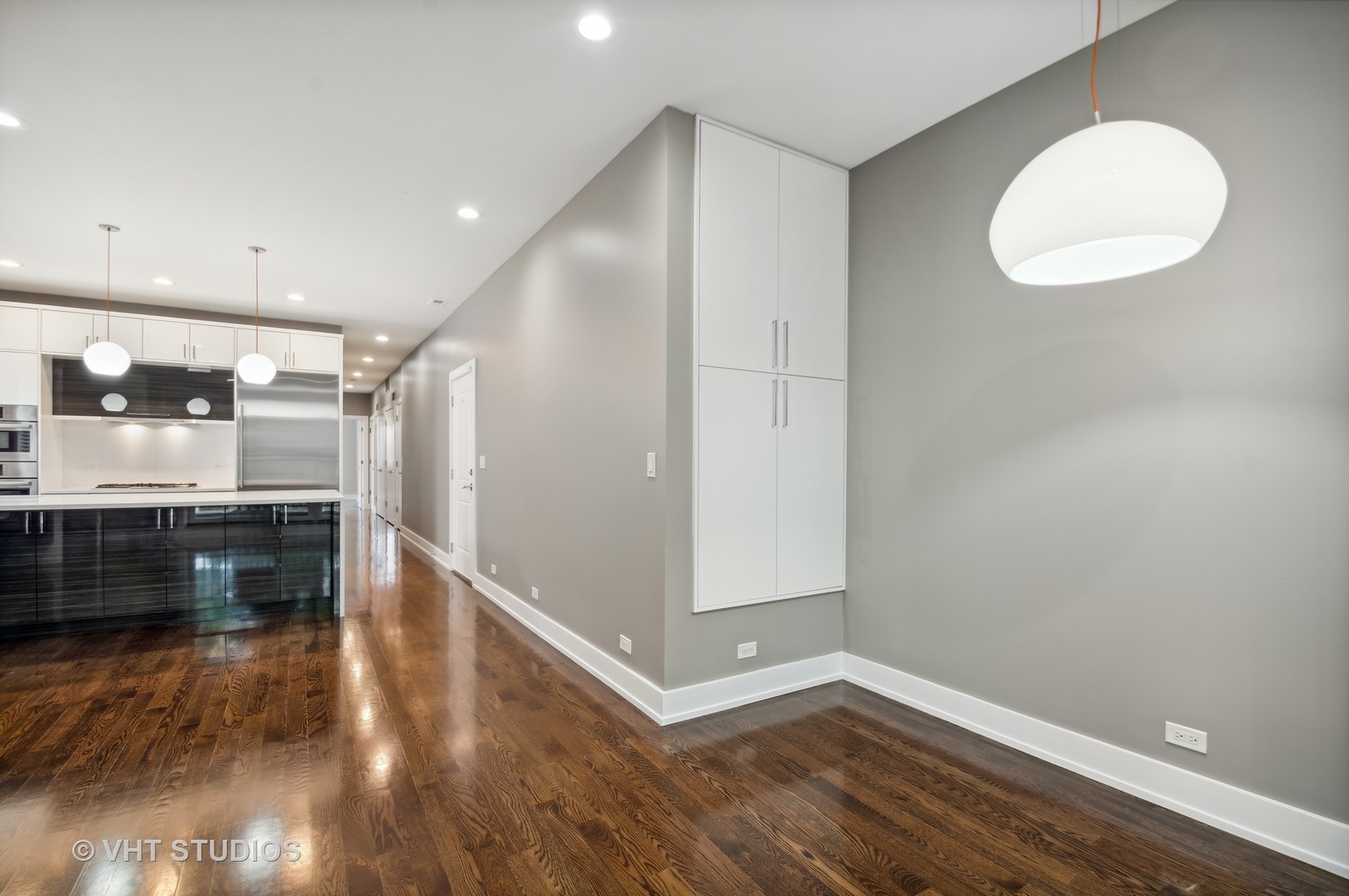 1741 West Roscoe Street, Unit 2 Chicago, IL 60657 - Photo 12 of 24 a view of a hallway with wooden floor