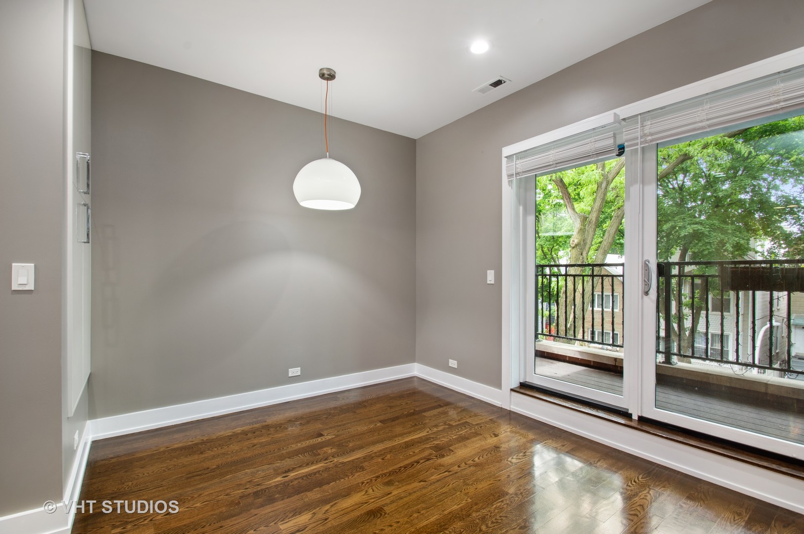 1741 West Roscoe Street, Unit 2 Chicago, IL 60657 - Photo 13 of 24 a view of empty room with wooden floor and fan