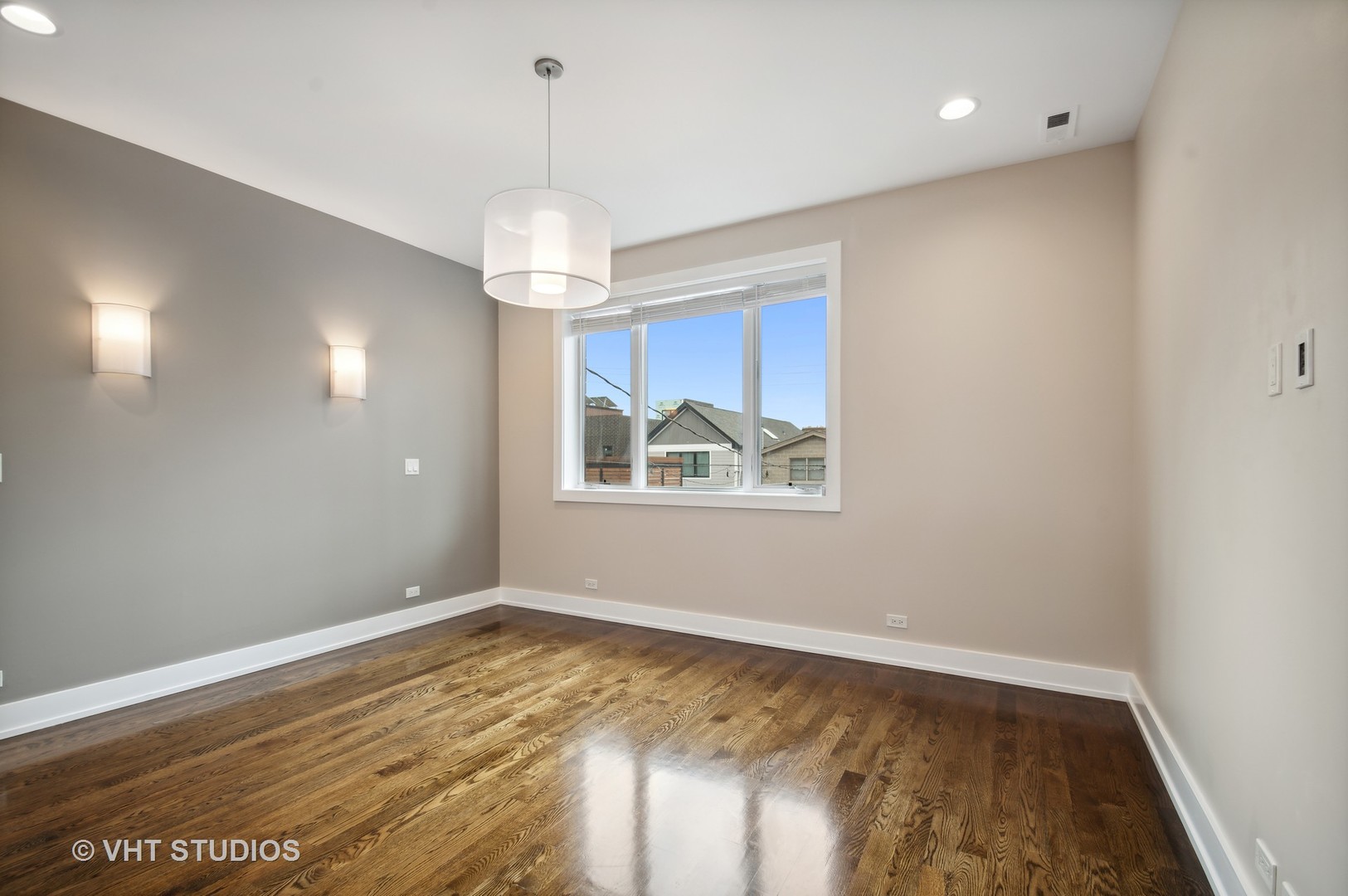 1741 West Roscoe Street, Unit 2 Chicago, IL 60657 - Photo 14 of 24 a view of an empty room with window and wooden floor