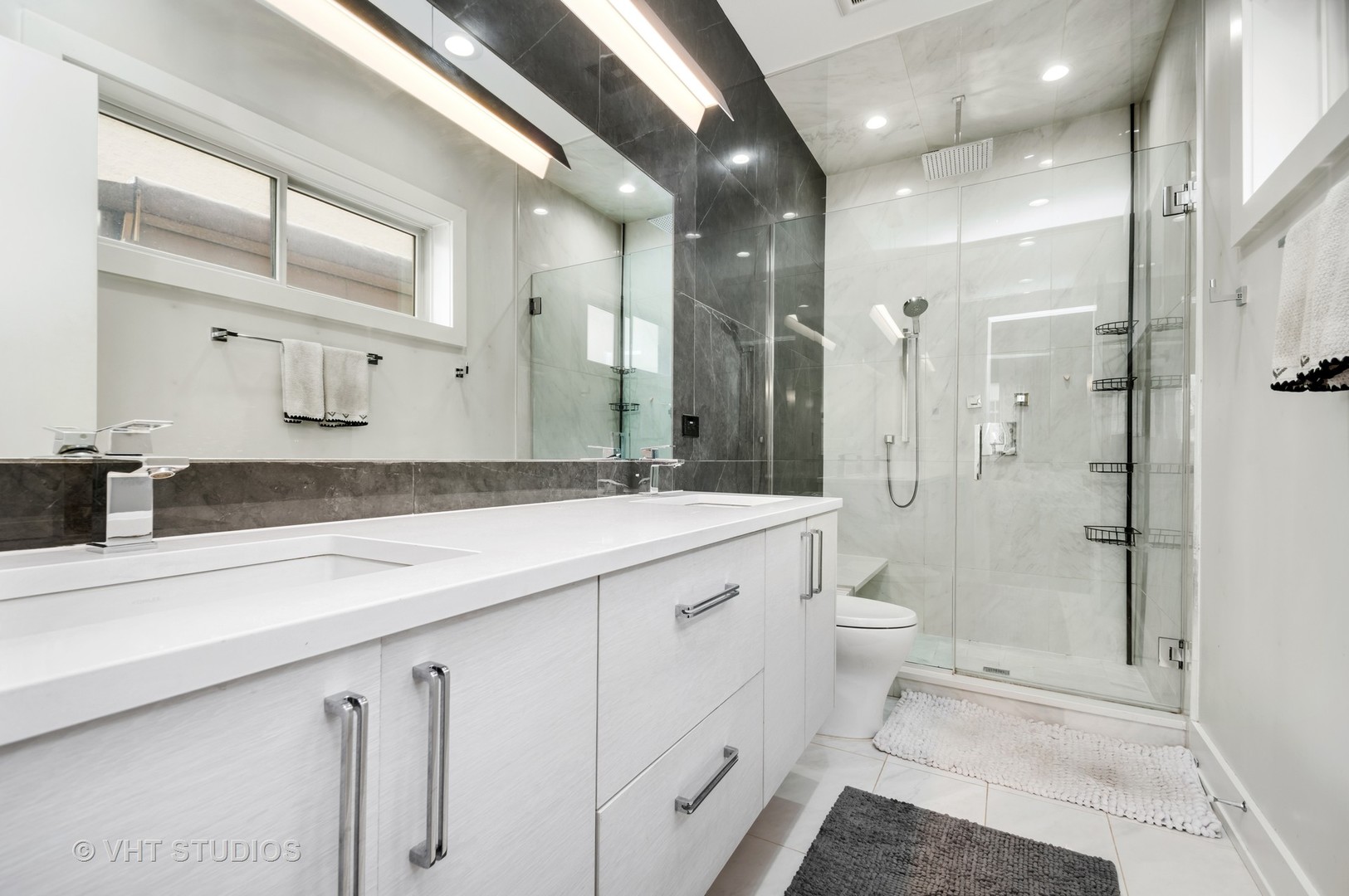 1741 West Roscoe Street, Unit 2 Chicago, IL 60657 - Photo 15 of 24 a bathroom with a granite countertop sink mirror and toilet