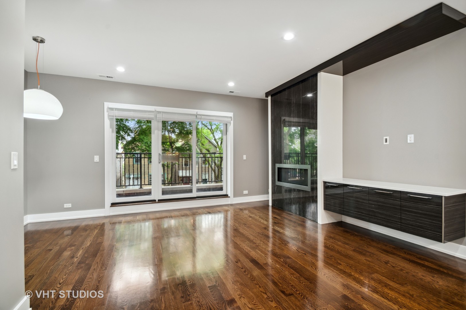 1741 West Roscoe Street, Unit 2 Chicago, IL 60657 - Photo 2 of 24 a view of an empty room with wooden floor and a window