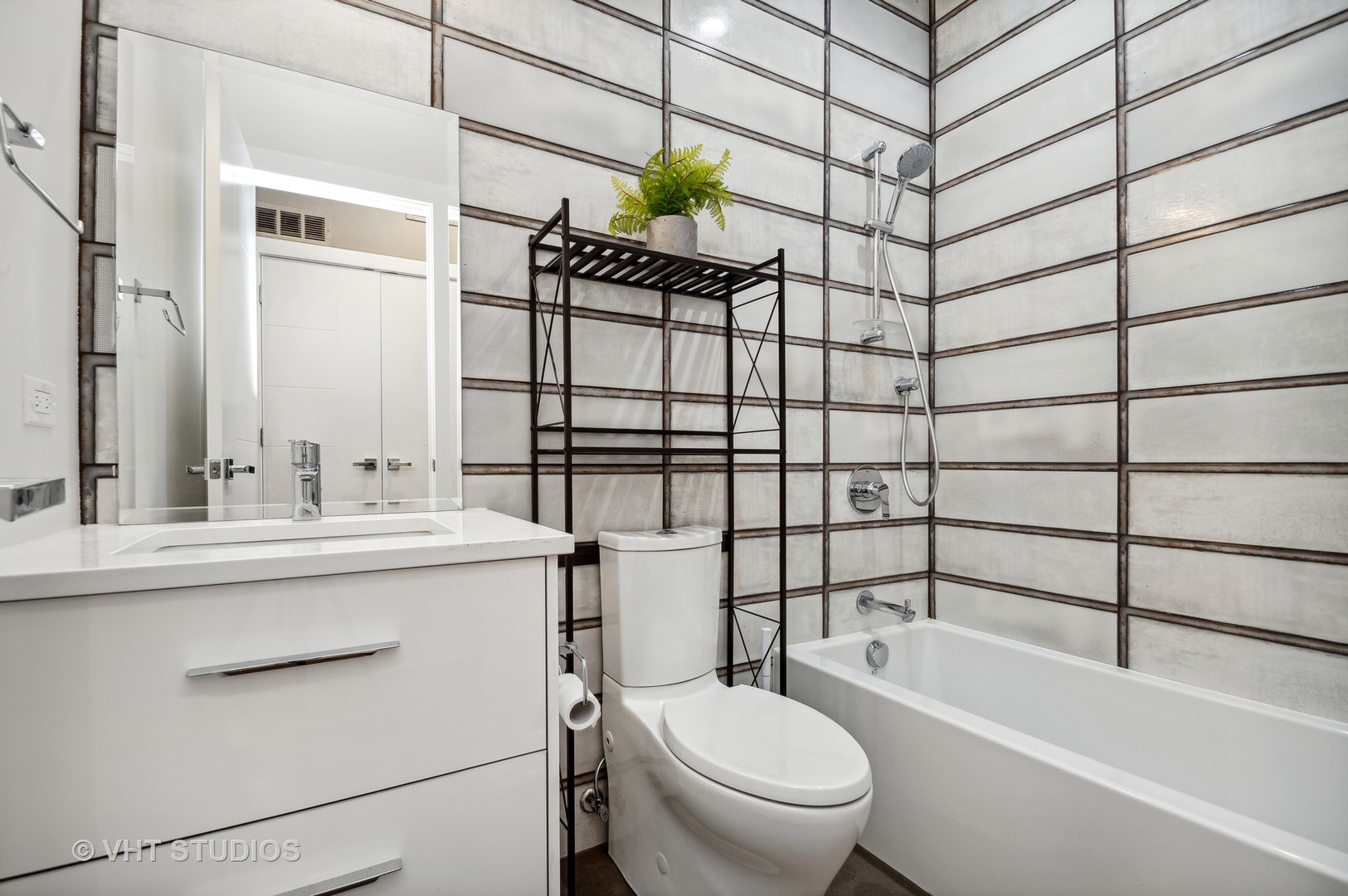 1741 West Roscoe Street, Unit 2 Chicago, IL 60657 - Photo 21 of 24 a bathroom with a sink toilet and shower